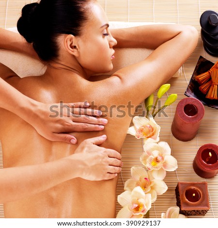 Adult woman in spa salon having body relaxing massage.
