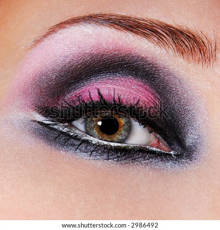 Black-violet make-up of eyes. Green eyes. Macro a photo of an eye.