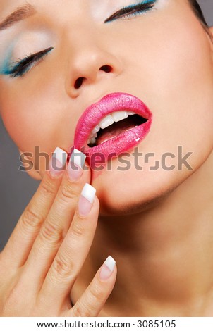 Glamour pink gloss lips with temptation gesture.