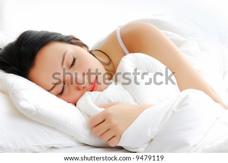 Beautiful woman lying and sleep on the snowy bed