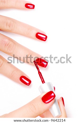 red nail polish. applying red nail polish