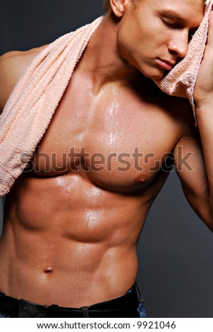 Young handsome muscular man with beautiful muscular body. Isolated on white.