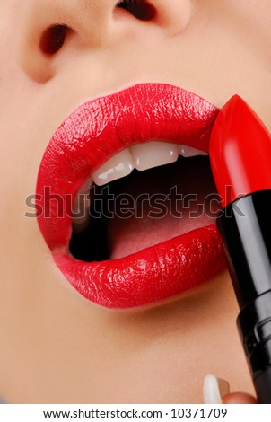 Luxury -  red lipstick. Woman applying cosmetic.