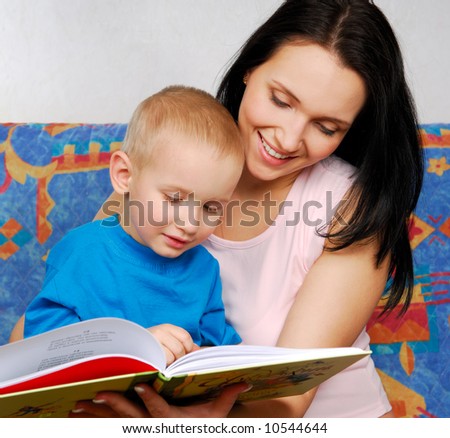 Beautiful mother reading  book for  son