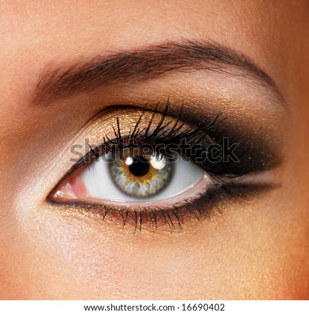  photo : Beautiful shape of female eye with golden-brown cosmetic make-up