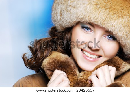 Close-up beautiful face of young woman in fur hat