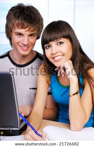 Two attractive students sitting with laptop - Clever people