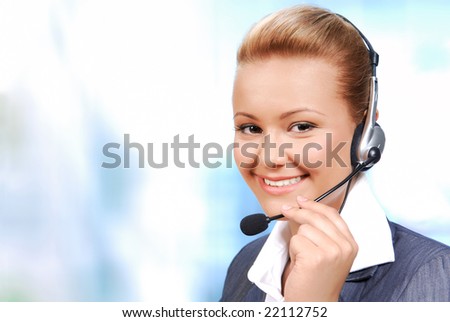 Smiling businesswoman speaking by hands-free. Isolated on the white background