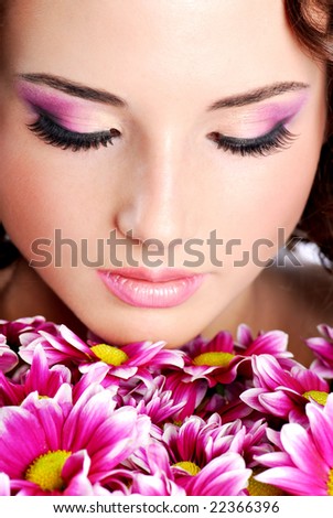 Young woman portrait with chrysanthemum. Spa treatment.