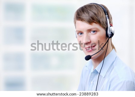 Close-up face of smiling man in headphones in work place
