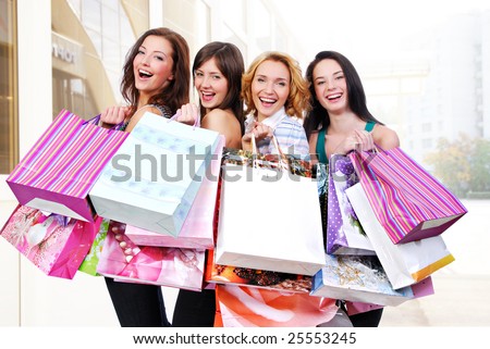 stock photo : Group of happy smiling women shopping with colored bags