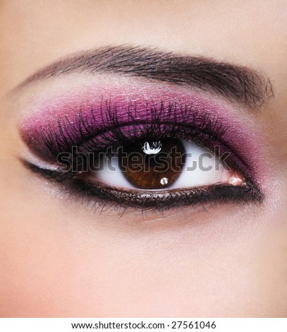 Front view of beauty female eye with purple make-up