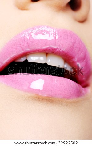 sexy female lips with bright pink lipstick on it - macro shoot