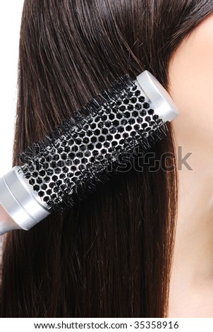 woman combing her hairs - macro shot