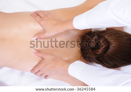 Healthy back massage for the young woman - white background