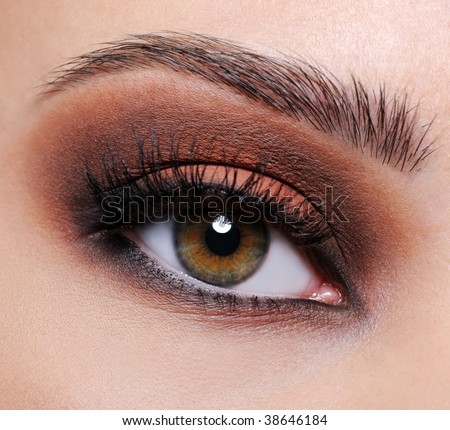 Front view of a close-up female eye with brown eyeshadow make-up
