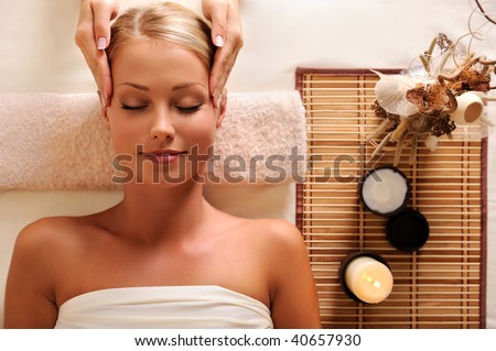 High angle portrait of an attractive female getting recreation massage of head