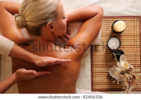Woman getting  recreation massage in spa salon - high angle