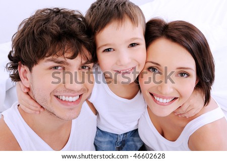 Beautiful smiling faces of  people. A happy young family from three persons