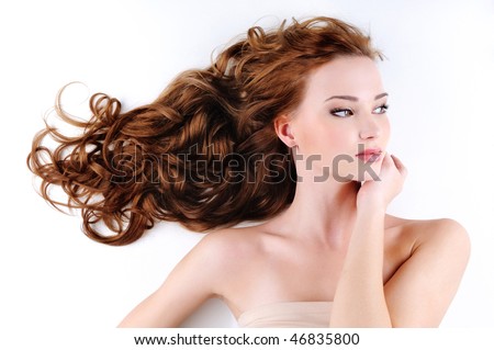 stock photo Portrait of the beautiful nice woman with red long ringlets 