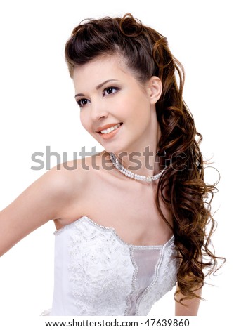  young smiling bride with modern wedding hairstyle long curly hairs