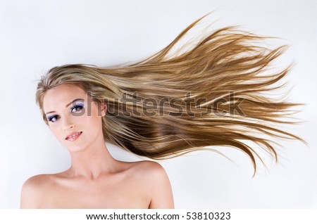 beautiful young female face with long blond straight hair as background