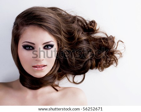 Face of a beautiful woman with beauty black eyes and long  brown hairs