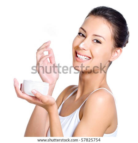 Beautiful laughing young woman with facial cream on her nose isolated on white Beautiful laughing young woman with facial cream on her nose isolated on white