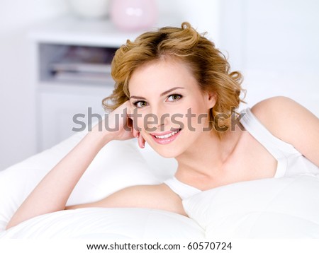 Portrait of beautiful smiling pretty woman relaxing - indoors