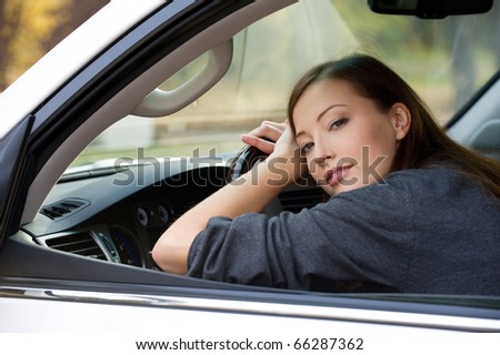 Portrait of attractive young woman in the new car  - outdoors