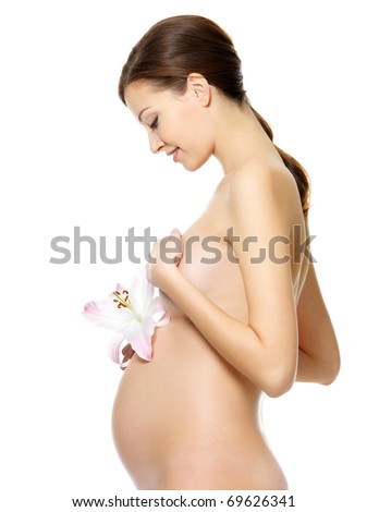 stock photo Beautiful pregnant woman with naked body holding flower on her 