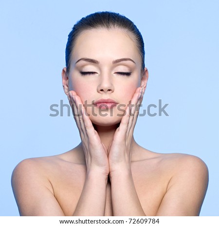 stock photo Clean face of beautiful teen girl touching her cheeks