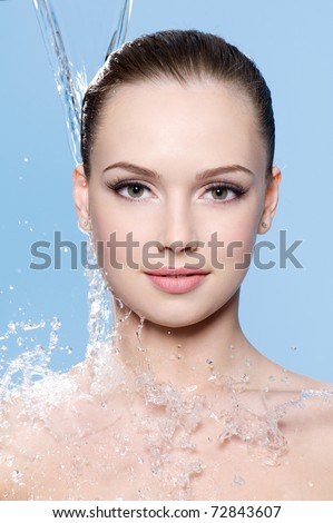 Portrait of beautiful clean face of teen girl under the stream of water