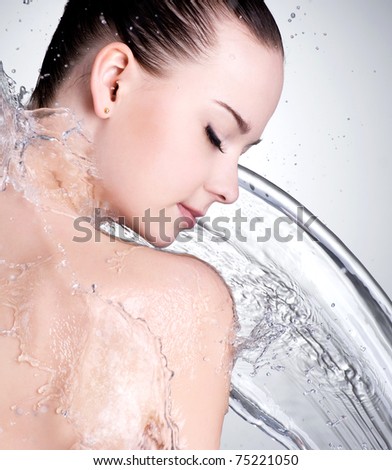 Portrait of beautiful female face with clean water - studio