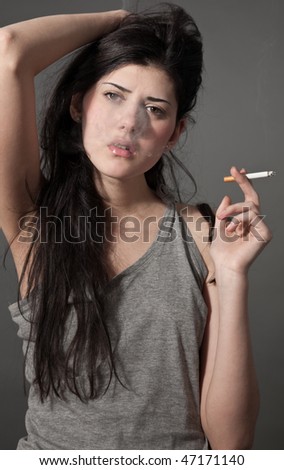 close-up portrait of young black hair smoking woman with cigarette