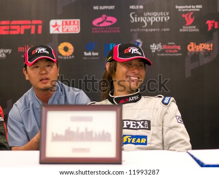 Ryuji Miki smiling while his interpretor answer questions for him at the press conference after finishing champion at the inaugural Formula Drift Singapore 2008 event April 27, 2008 in Singapore.