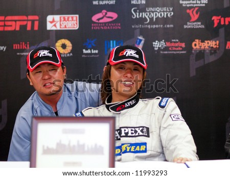 Ryuji Miki smiling while his interpretor answer questions for him at the press conference after finishing champion at the inaugural Formula Drift Singapore 2008 event April 27, 2008 in Singapore.