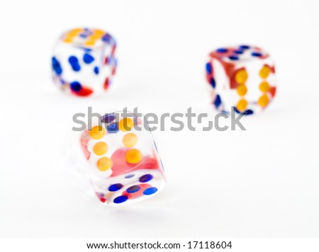 Motion blurred spinning dice against a background of two thrown dice
