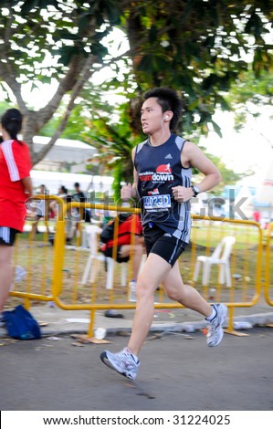 SINGAPORE - 31 May: Ultra Marathon runner finishing his 84 km in  the Adidas Sundown Marathon held in Singapore on 30 and 31 May 2009.