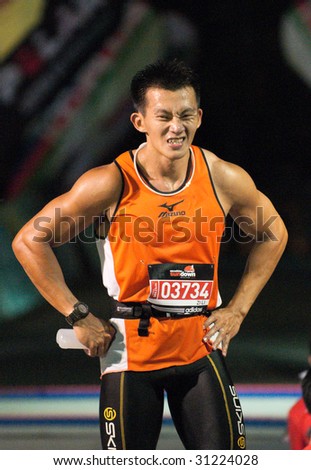 SINGAPORE - 31 May: Marathon finisher in  the Adidas Sundown Marathon held in Singapore on 30 and 31 May 2009.