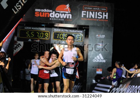 SINGAPORE - 31 May: Crossing the finish line at the Adidas Sundown Marathon held in Singapore on 30 and 31 May 2009.