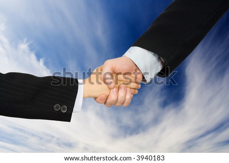 Hand shake of the man and the boy in suits