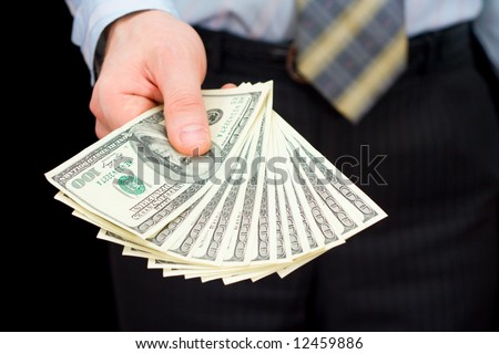 The man in a suit, offering a pack of dollars
