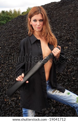 young female posing with sword dressed in men\'s shirt