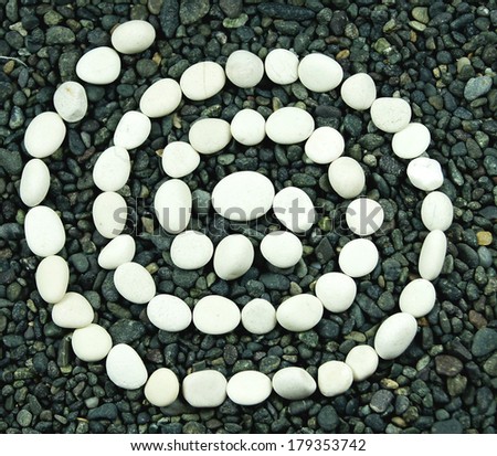arrangement of white stone circle on black stone background