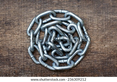 pile of iron chain on wooden texture background