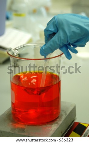 young scientists hand with transfer pipette in mixing solution