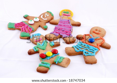 brightly colored gingerbread men cookies against a white background
