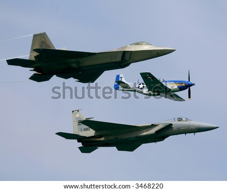 A view of three different types of military fighter aircraft from three different eras.  A P51 propeller aircraft, a modern F15 jet fighter and the futuristic F22.