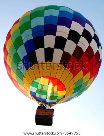 Hot air balloon in flight against a light blue sky